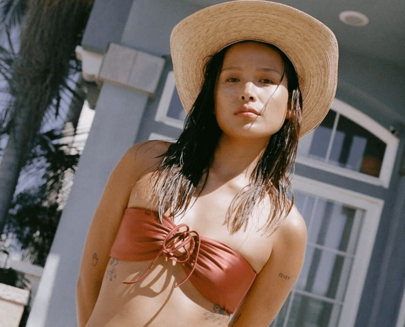 Woman in a copper bikini beach vacation outfit idea