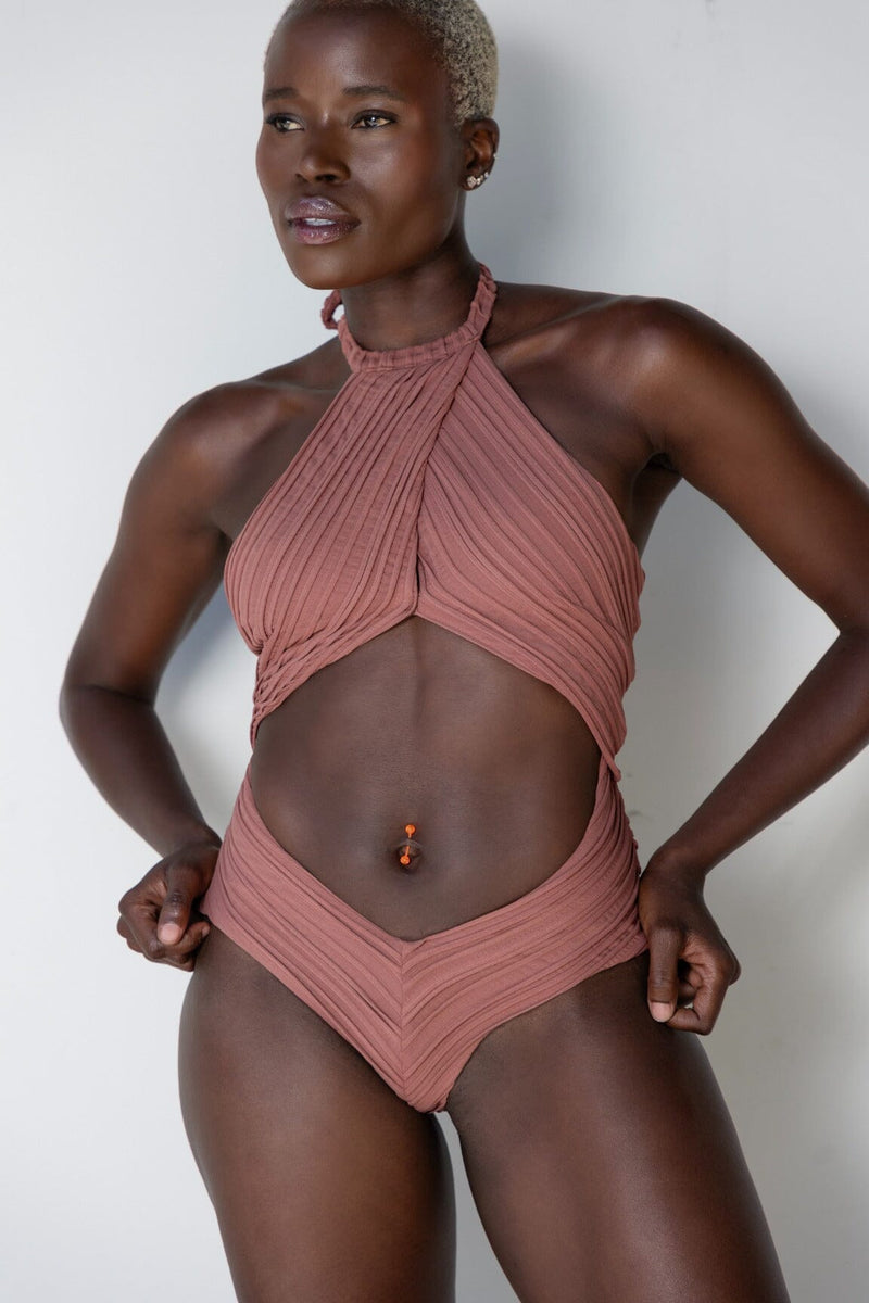 a model facing forward in a halter one-piece swimsuit