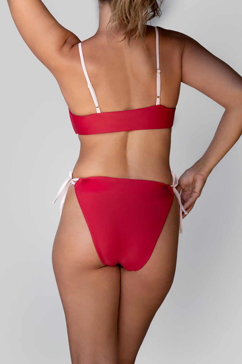 a model showing the back of a red bikini